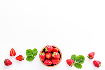 Fresh strawberry with leaf in bowl. Berry background. Top view