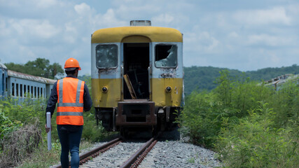 Wall Mural - train on the railway. worker , engineer walk on railways with Bogie on background.