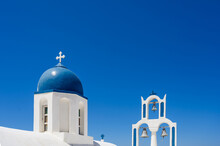 White And Blue Bell Tower Of The Traditional Greek Orthodox Church On The Island Of Santorini. Blue Sky On Background.