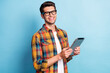 Portrait of attractive cheerful guy geek using device app 5g searching web isolated over bright blue color background