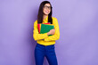© deagreez - Photo of dreamy young attractive happy lady look empty space hold hands textbooks isolated on violet color background