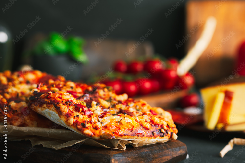 Pizza. Mini italian pizzas with cheese, pepper and tomatos. Pizza on wooden plate. - obrazy, fototapety, plakaty 
