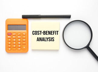 Calculator, magnifying glass, pen and notepad wirtten Cost-Benefit Analysis. cost-benefit analysis is a systematic process that businesses use to analyze during decision making