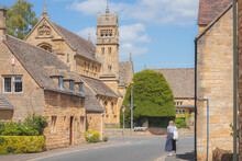 A Young Female Tourist Explores The Charming, Quaint English Village Of Chipping Campden On A Sunny Summer Day In The Cotswolds, Gloucestershire, England.