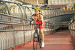 © zinkevych - Slim and fit girl in bright sportswear and protective helmet with a bike