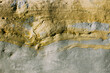sinuous abstract lines on a gray-yellow stone