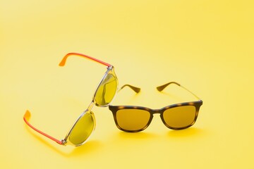 Brown glasses on yellow background