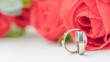 Wedding rings lie near a beautiful bouquet as bridal accessories.Wedding rings and roses bouquet.concept for a wedding card.