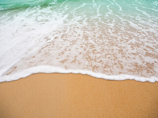 White foam wave blue sea on sand beach background at coast close up. wonderful Phuket island ocean  nature landscape outdoor. flat lay with free space. tropical tourist summer holidays travel concept.