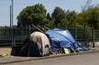 Homeless tent and tarp shelter on the street over a highway in Portland, Oregon.