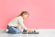 © Pixel-Shot - Cute little girl playing chess at home