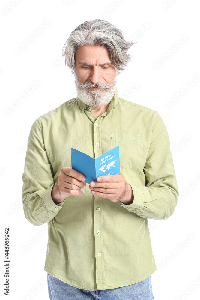 Senior man with immune passport on white background