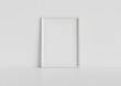 © sdecoret - White frame leaning on white floor in interior mockup. Template of a picture framed on a wall 3D rendering