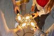 © Studio Romantic - A group of business people holding light bulbs. A team of colleagues as a conceptual metaphor for collaborating and sharing ideas in the creative community.