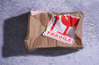  damaged parcel with fragile sticker on the floor