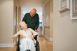 © Rido - Senior man visit disabled woman on wheelchair at nursing home