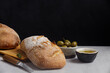 Rustic sourdough ciabatta bread with olives on a concrete table. Freshly baked artisan ciabatta bread 