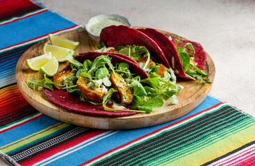 Mexican national food - taco wheat beetroot tortilla with vegan chickpea balls and vegetables