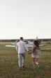 © pavelvozmischev - A couple of lovers, in the cockpit on their own plane. Smiling people and a private plane in the background.