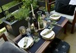 Outdoor living space. Dinner party on the small terrace. Low table set up.