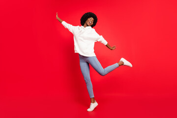 Poster - Full size photo of lovely wavy hairdo lady dance wear white sportswear jeans isolated on red color background