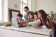 © Studio Romantic - Smart children pupil pointing at laptop screen while discussing media material or online project with teacher on lesson in school classroom. Curious diverse elementary students and female educator