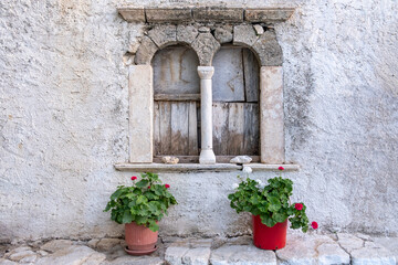 Wall Mural - Folegandros island, Windows of an old church at Chora town square. Greece, Cyclades.