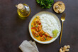© Vladislav Chusov - Chicken tikka masala curry with rice, herbs and peppers. Indian food. National cuisine.
