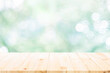 © ijeab - empty wooden table on green bokeh background