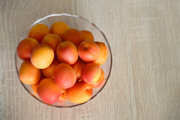 Sticker - Top view of fresh ripe apricots in bowl with copy space