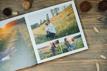 Luxury Wooden Photo Book On Natural Background. Family Memories Photobook. Save Your Summer Vacation Memories.