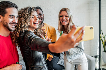 Wall Mural - Group of friends taking a selfie with a mobile phone.