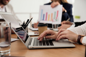 Sticker - Woman using laptop at table in office during business meeting, closeup. Management consulting