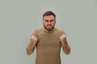 © New Africa - Angry young man on grey background. Hate concept