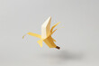 © Yaroslav Danylchenko/Stocksy - Papercraft yellow banana with open peel