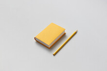 Yellow Papercraft Book With Blank Cover And Pencil