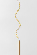 Yellow Paper Clips And Pencil In Curve