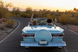 © Raymond Forbes Photography/Stocksy - Happy Fun Sunset Cruise on rural road in Arizona
