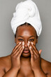 © McKinsey Jordan/Stocksy - Black Woman Using Hands To Apply Skincare Products