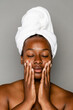 © McKinsey Jordan/Stocksy - Black Woman Applying Skincare Routine To Her Face
