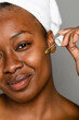© McKinsey Jordan/Stocksy - Portrait Of Black Woman Applying Facial Oil