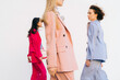 © Ivan Ozerov/Stocksy - different women in colored suits walk along the walls