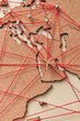 © Yaroslav Danylchenko/Stocksy - Small plane model on map with red connections