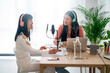 © Studio Marmellata/Stocksy - Cheerful Asian women communicating while recording podcast