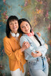 © Studio Marmellata/Stocksy - Positive Asian woman against colorful wall