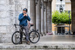 © Hakan & Sophie/Stocksy - man puts on bicycle helmet