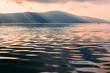 © Alexandra Bergam/Stocksy - Beautiful sea and mountain at sunset