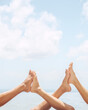 © Duet Postscriptum/Stocksy - Female feet in the pool against the blue sky