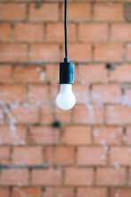 A Light Bulb With Brick Background