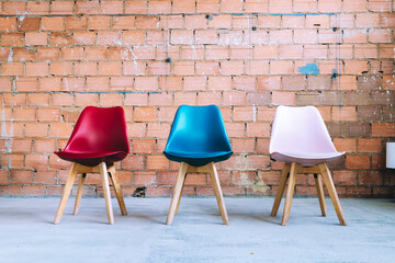 Chairs on brick wall